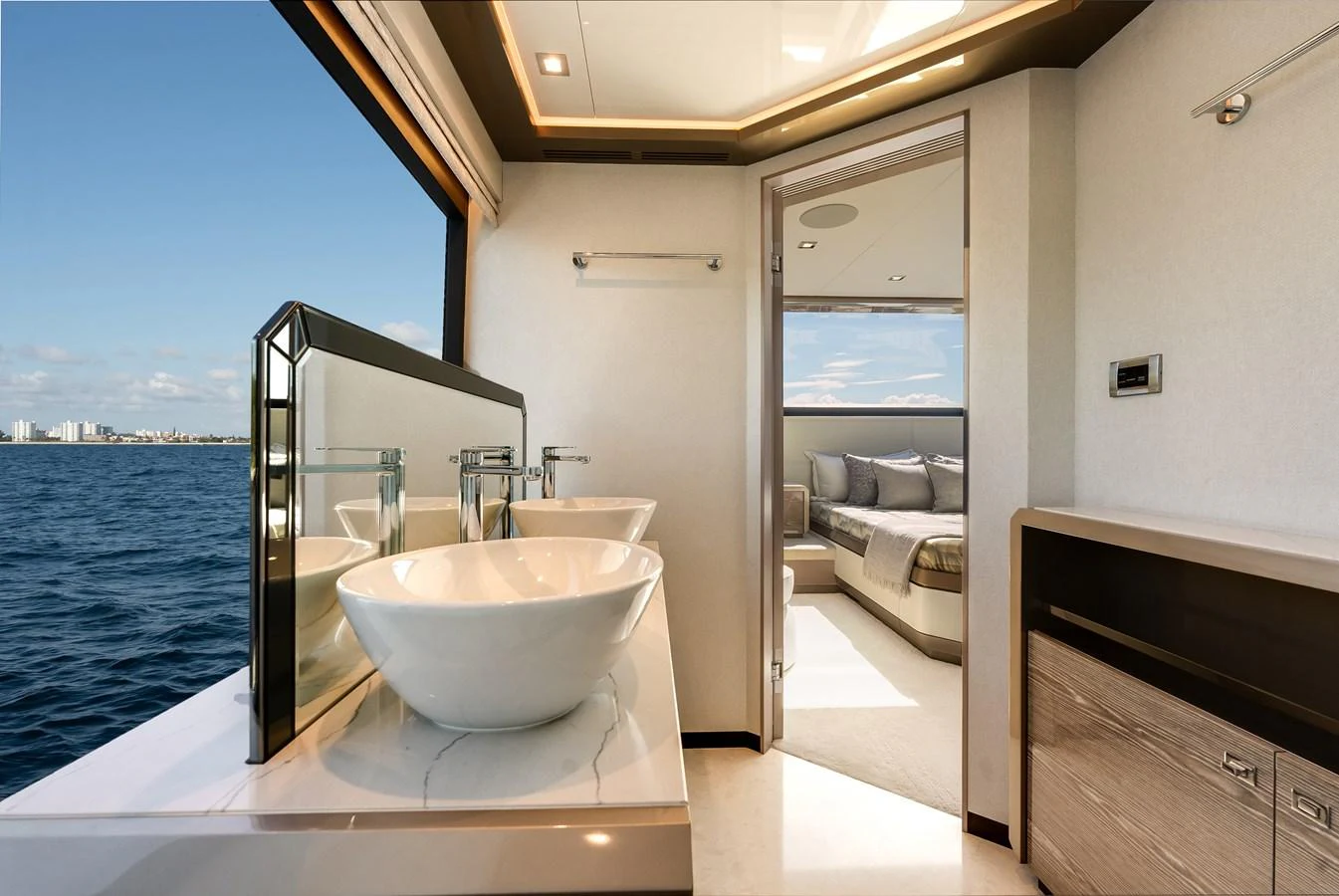 This luxurious yacht bathroom features dual sinks and a stunning ocean view. aboard CHAOS Yacht for Sale