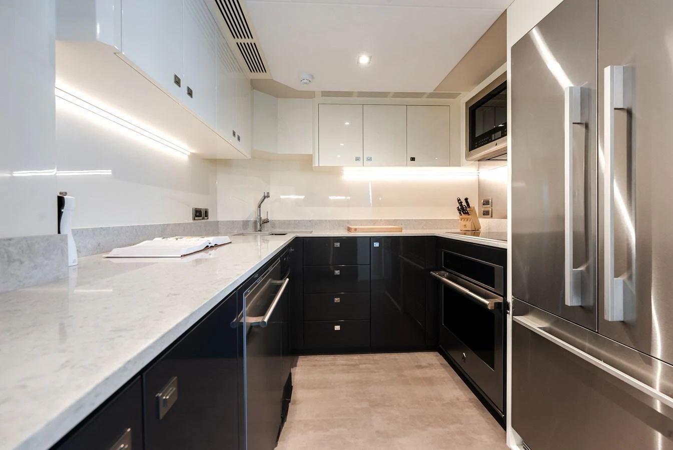 The yacht's galley features modern appliances and sleek cabinetry, offering a stylish and functional space for meal preparation. aboard CHAOS Yacht for Sale