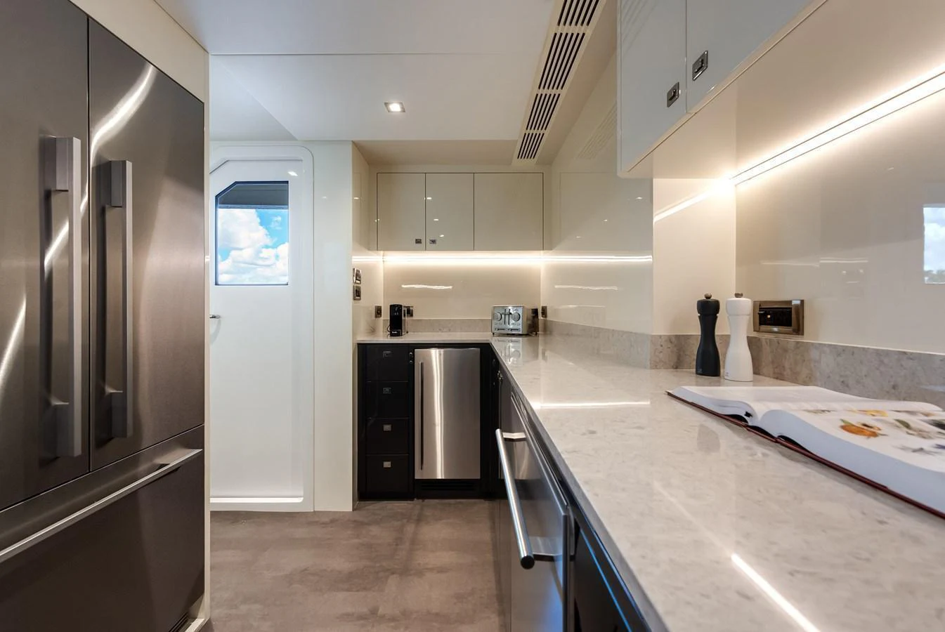 The yacht's galley features modern appliances and sleek countertops, creating a stylish and functional space. aboard CHAOS Yacht for Sale
