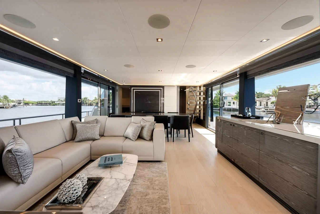 The salon features a spacious and modern design with ample seating and large windows for natural light. aboard CHAOS Yacht for Sale