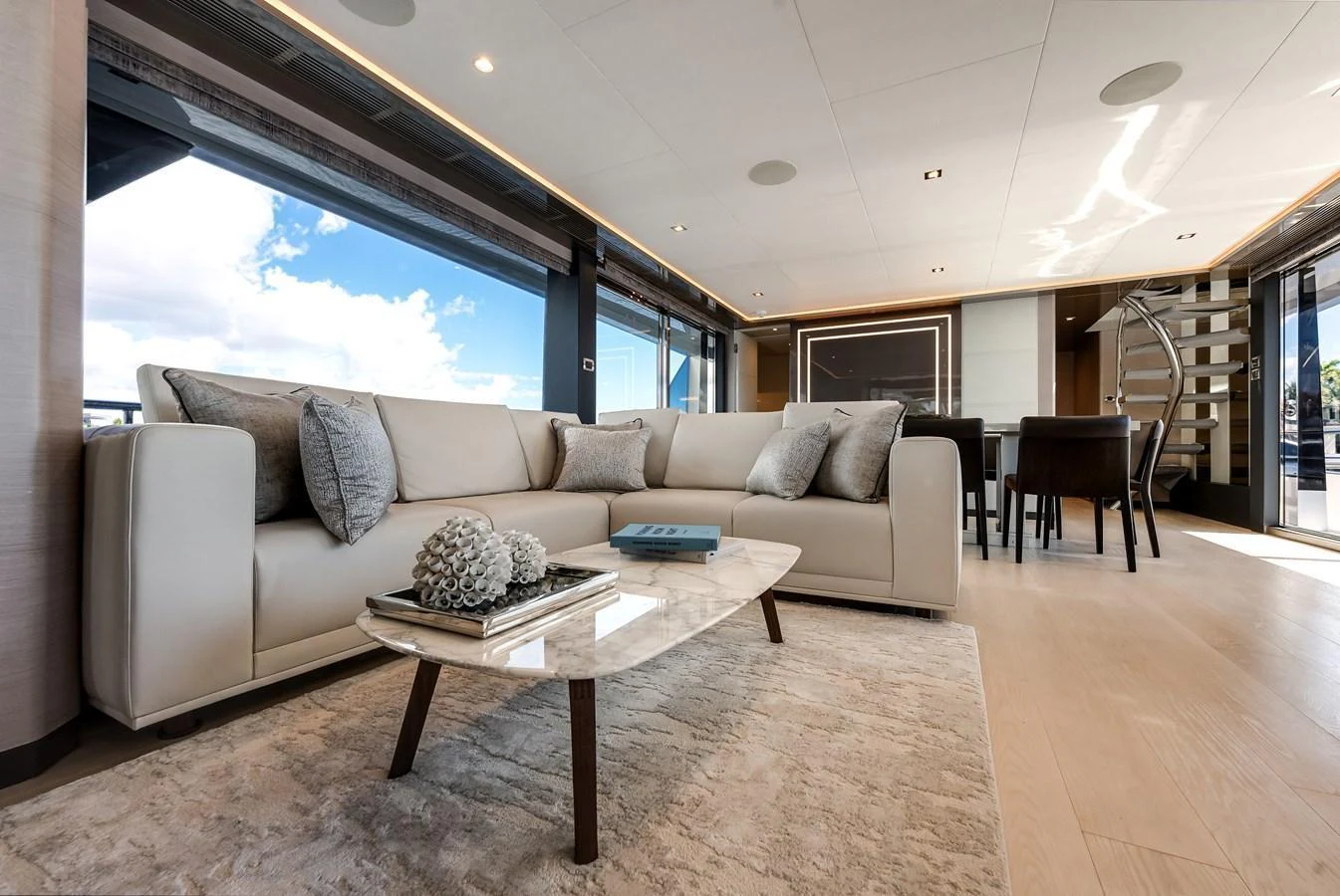 The salon features a luxurious seating area with modern furnishings and ample natural light. aboard CHAOS Yacht for Sale