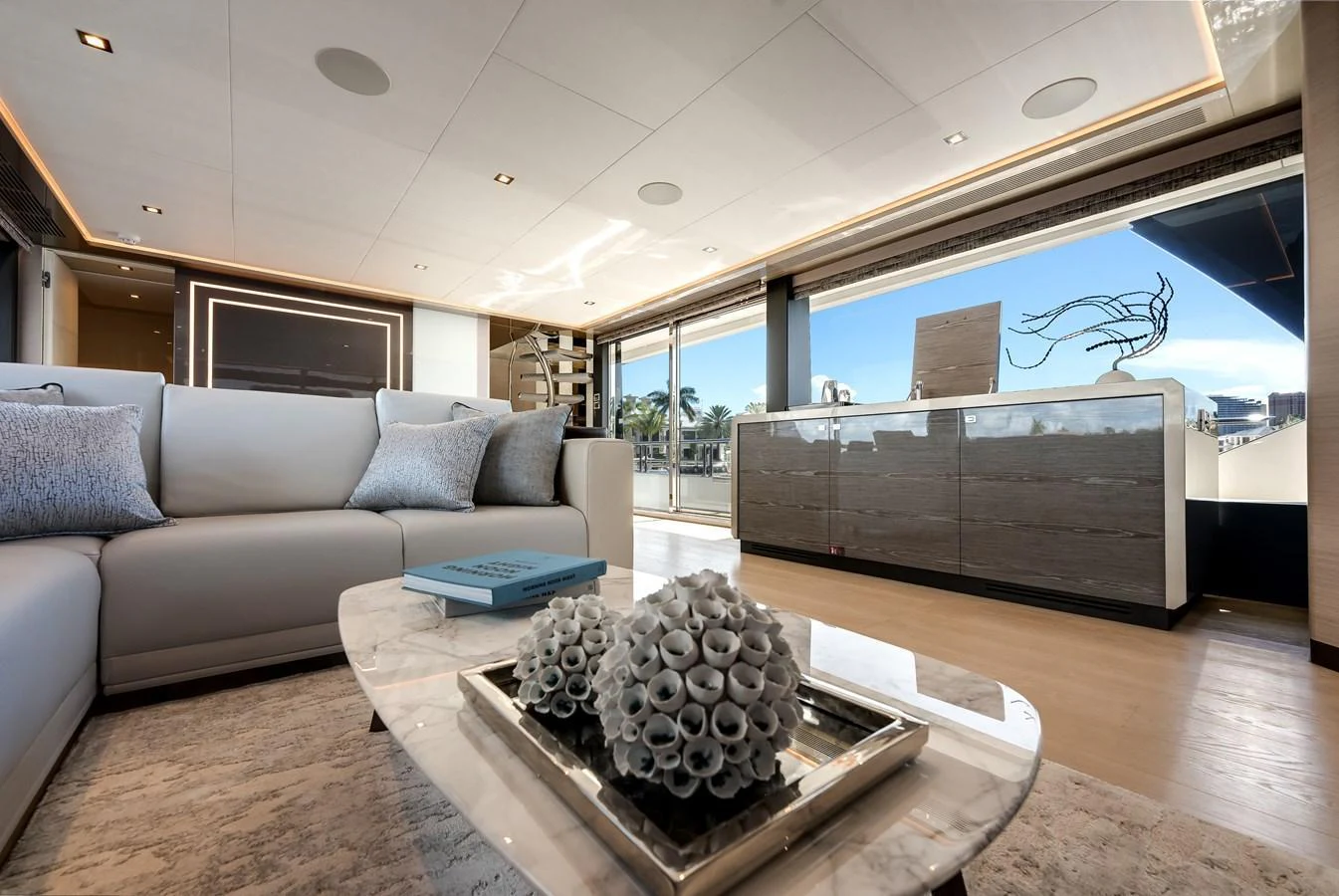 The yacht's salon features a luxurious seating area with modern decor and ample natural light. aboard CHAOS Yacht for Sale