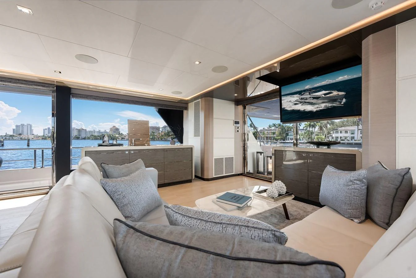 The salon offers a luxurious and spacious area with comfortable seating and a stunning view of the water. aboard CHAOS Yacht for Sale