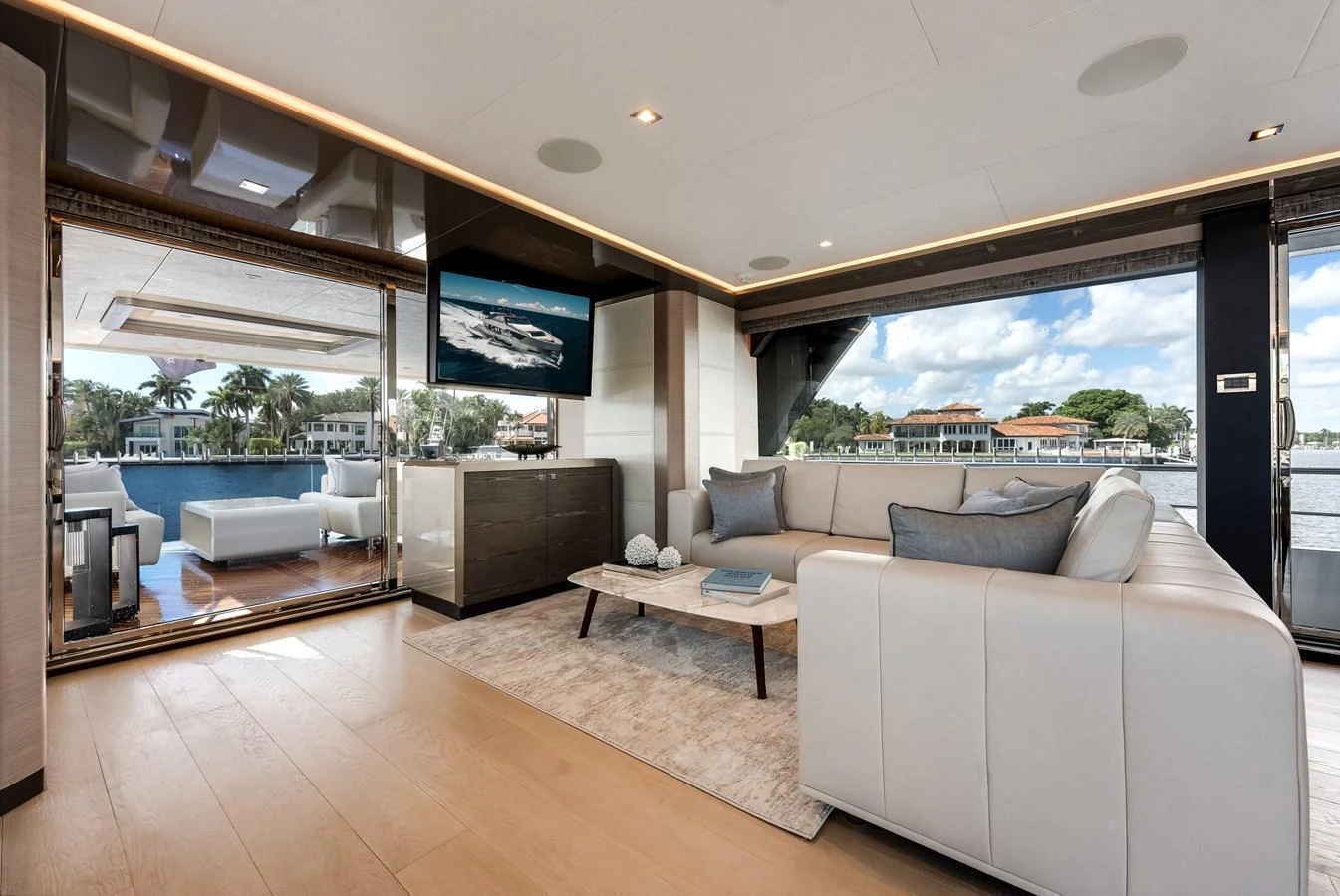The salon offers a spacious and elegant area with comfortable seating and a stunning view of the water. aboard CHAOS Yacht for Sale
