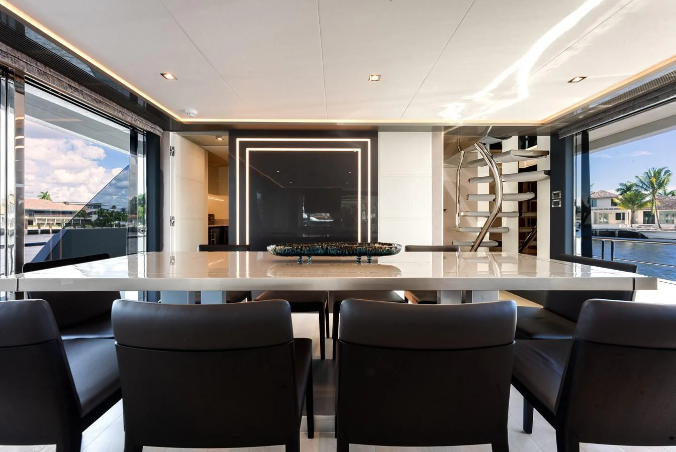 The yacht's dining area features a sleek, modern design with ample seating and a sophisticated ambiance. aboard CHAOS Yacht for Sale