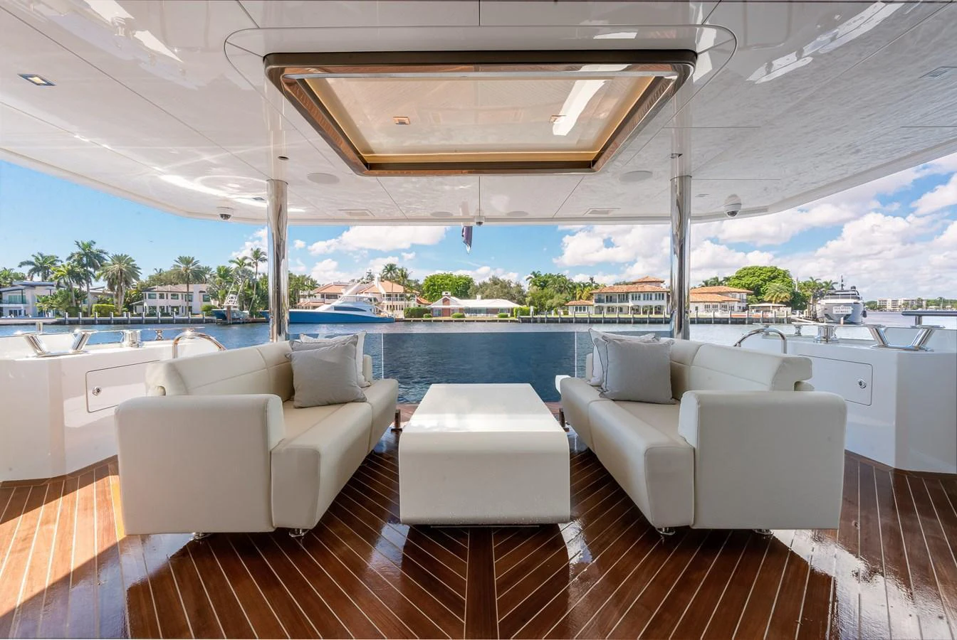 The aft deck features luxurious seating with a stunning view of the water. aboard CHAOS Yacht for Sale