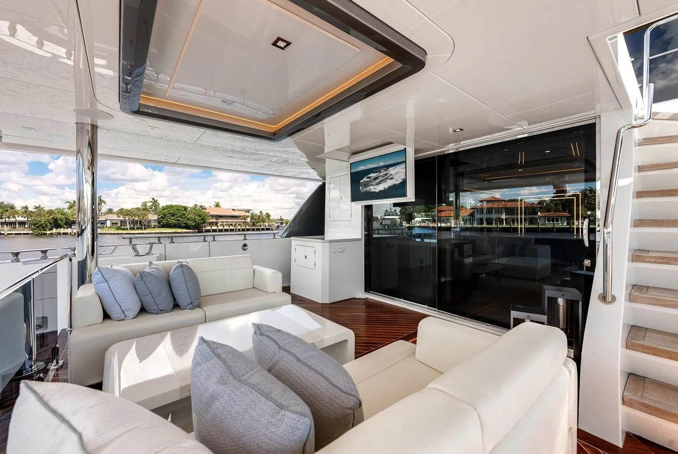 The aft deck features a comfortable seating area with plush cushions and a view of the water. aboard CHAOS Yacht for Sale