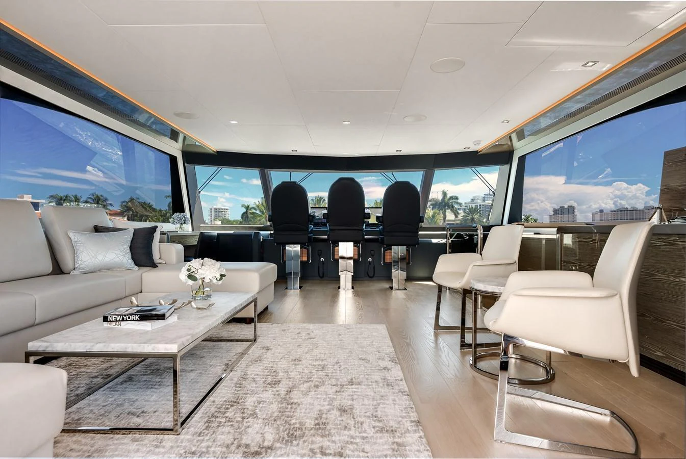 The salon offers a spacious and luxurious seating area with panoramic views and modern furnishings. aboard CHAOS Yacht for Sale