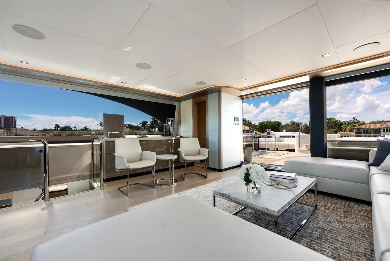 The salon features modern furnishings and large windows for a bright, open atmosphere. aboard CHAOS Yacht for Sale