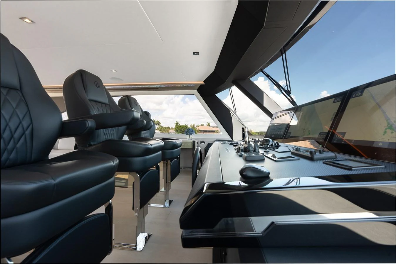 The helm station features luxurious seating and state-of-the-art navigation equipment, offering a commanding view of the surroundings. aboard CHAOS Yacht for Sale