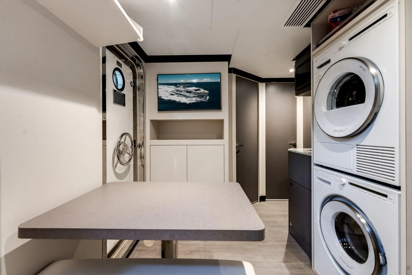 The crew area features a compact dining space and laundry facilities, ensuring comfort and convenience for the crew. aboard CHAOS Yacht for Sale