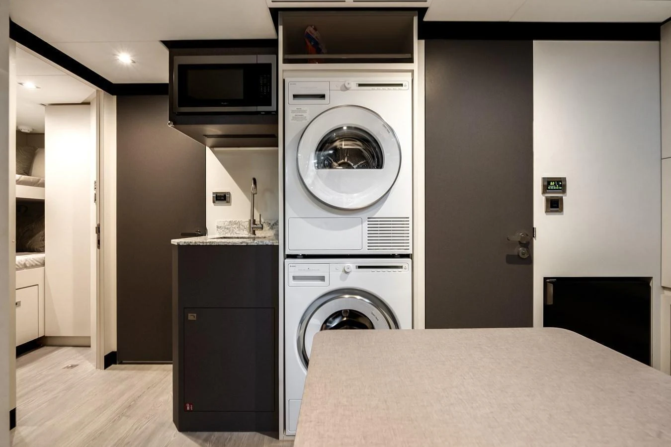 The yacht features a well-equipped laundry area with modern appliances. aboard CHAOS Yacht for Sale