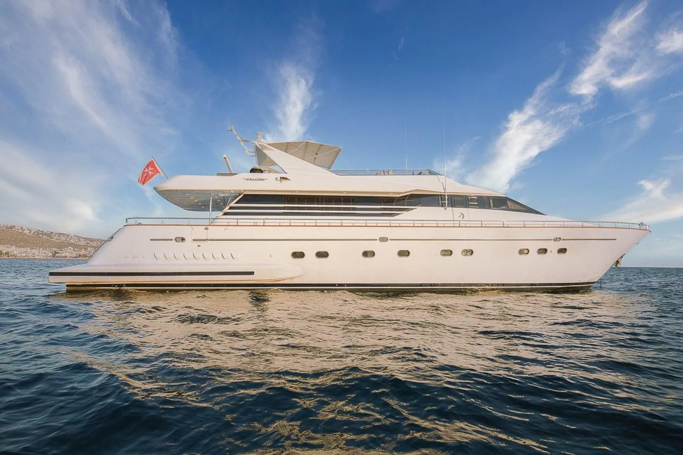 A sleek and elegant yacht cruising on calm waters under a clear blue sky. aboard D-FORCE Yacht for Sale