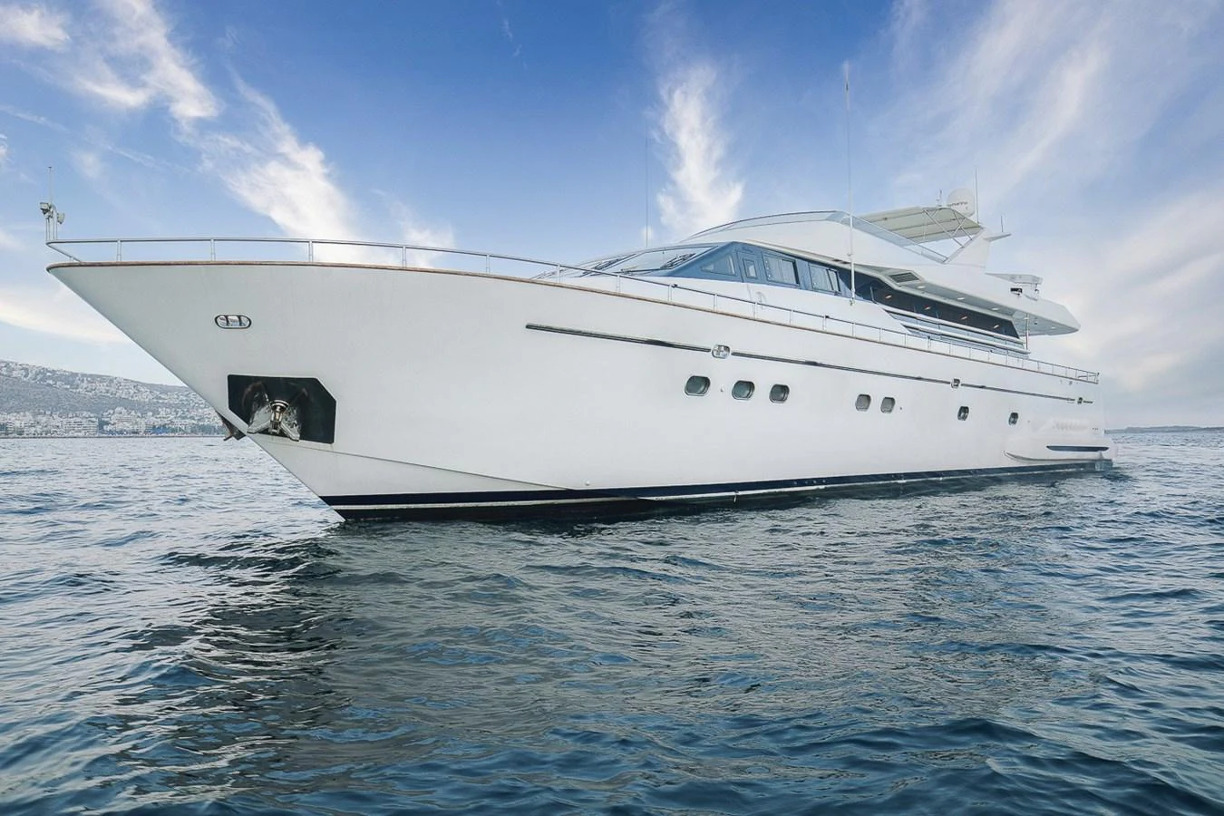 A sleek and modern yacht glides gracefully on the open water under a clear blue sky. aboard D-FORCE Yacht for Sale