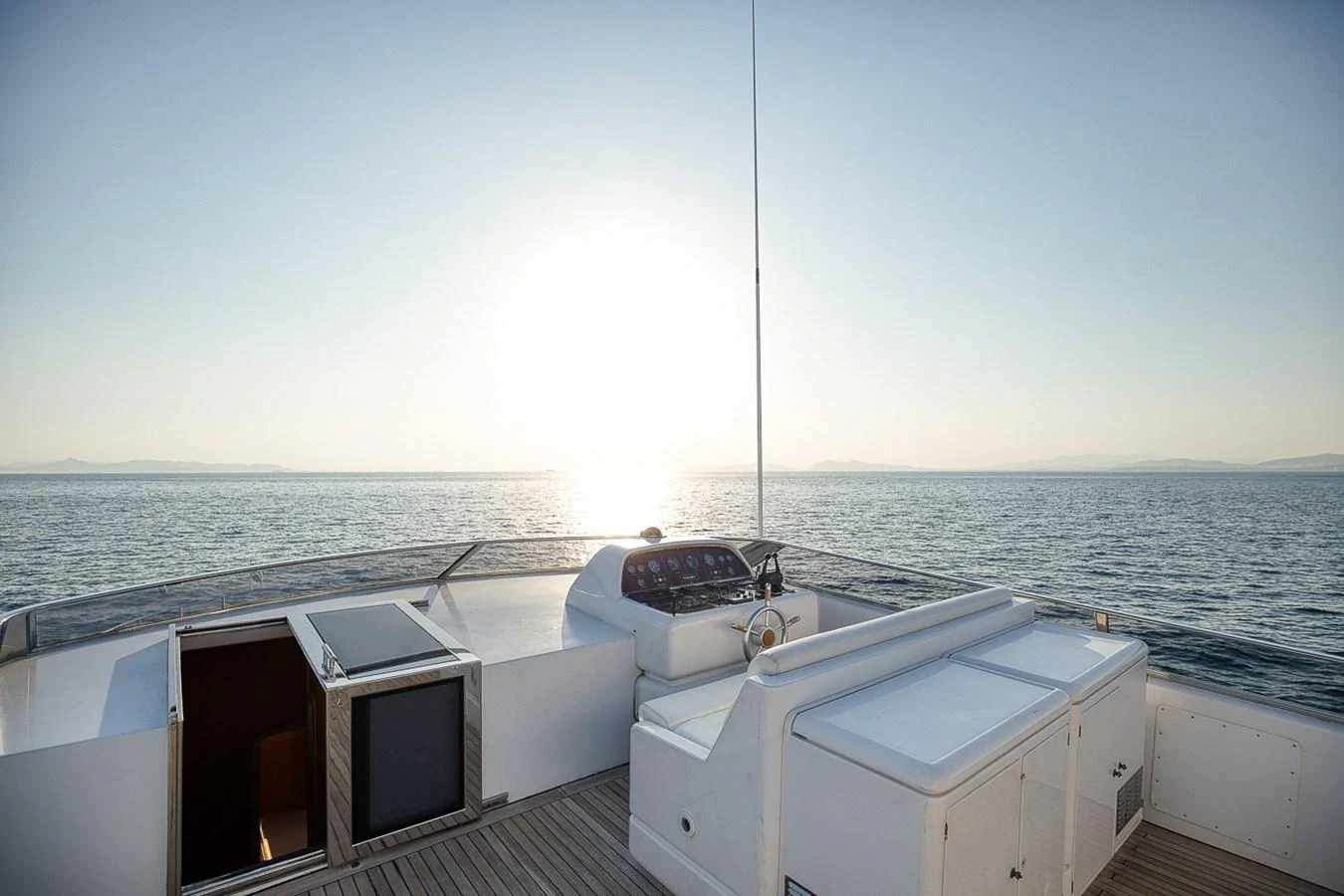 The flybridge offers a serene view of the open sea with ample seating and navigational controls. aboard D-FORCE Yacht for Sale