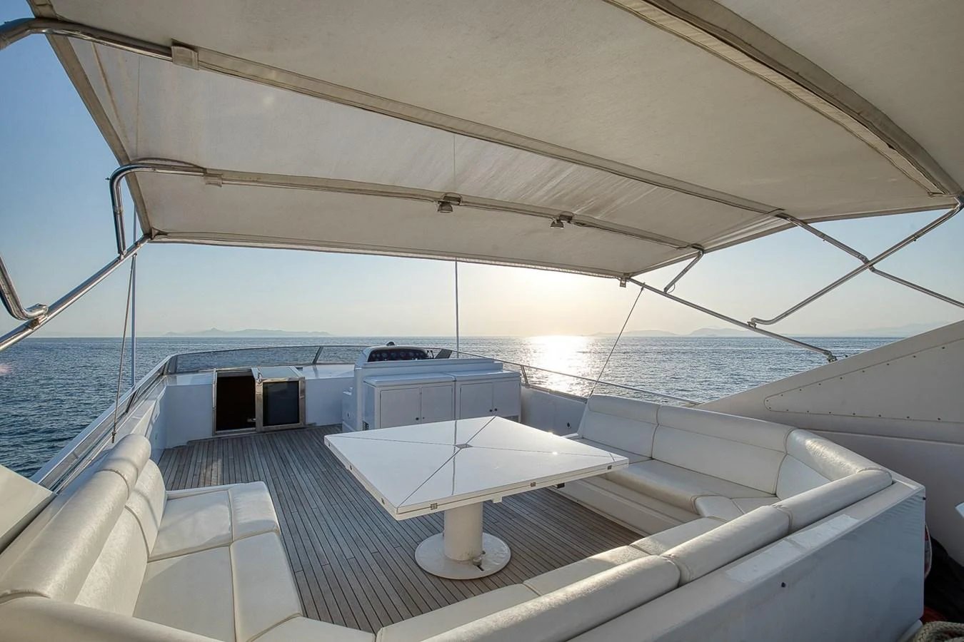 The flybridge offers a spacious seating area with a large table, perfect for enjoying the ocean views. aboard D-FORCE Yacht for Sale