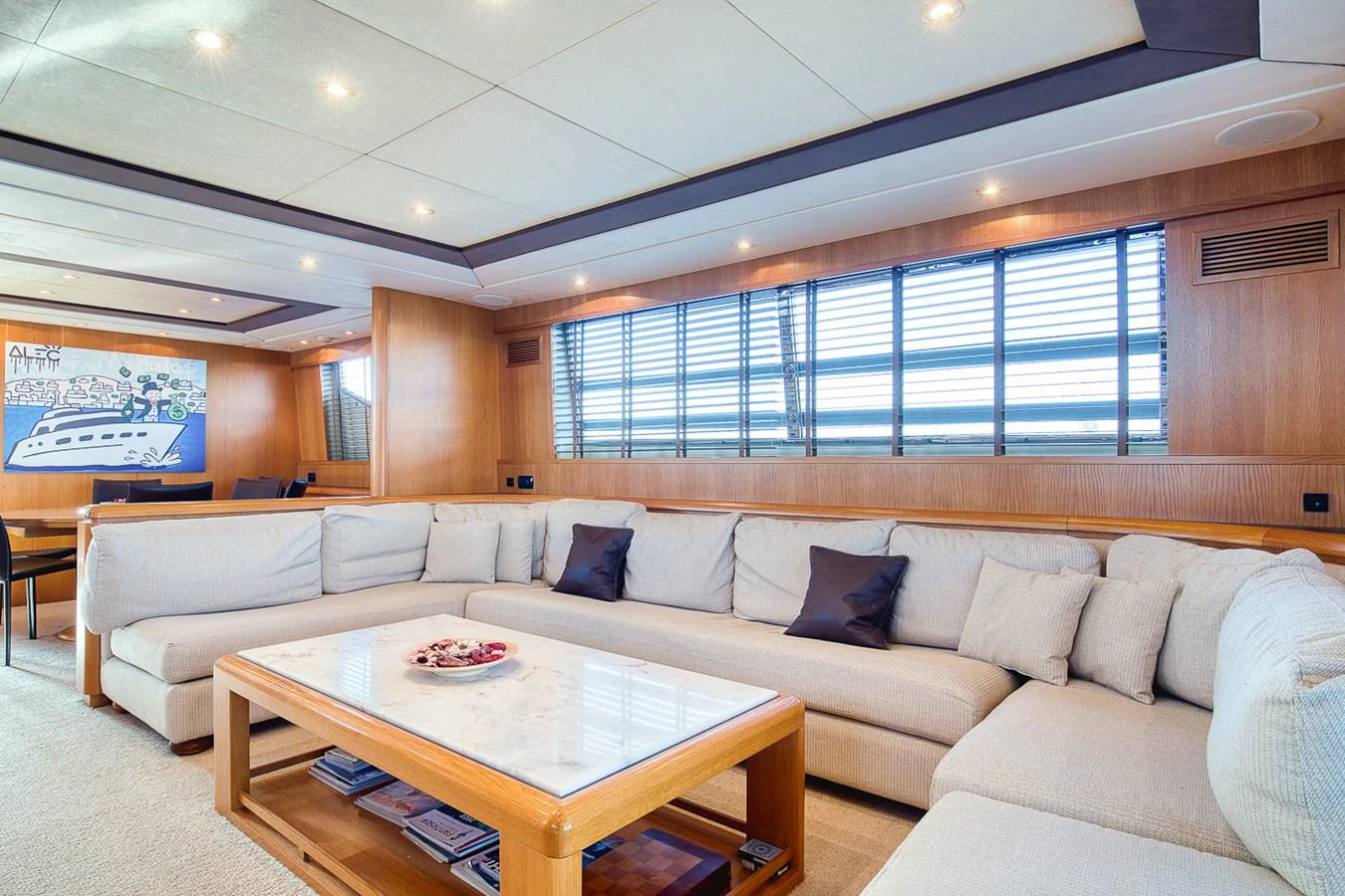 The yacht's salon features a spacious and comfortable seating area with a large sectional sofa and a coffee table. aboard D-FORCE Yacht for Sale