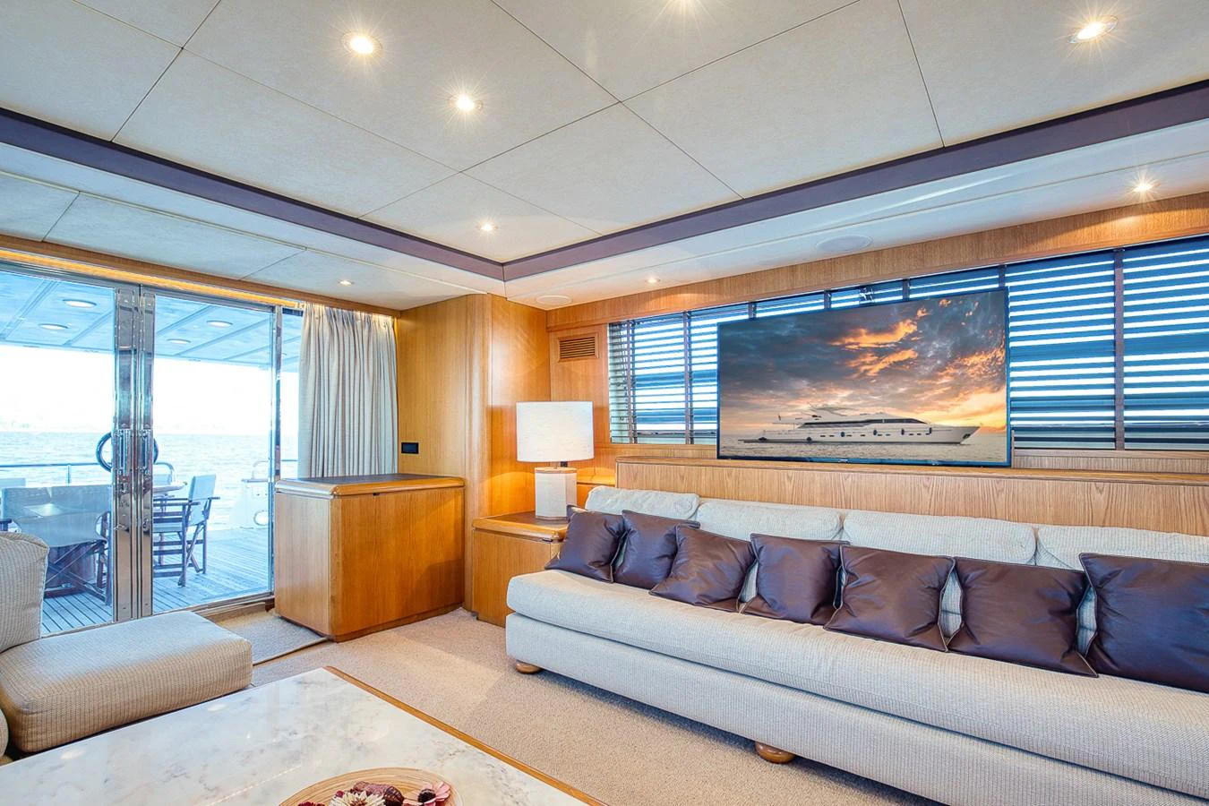 The yacht's salon features a comfortable seating area with a large TV and ample natural light. aboard D-FORCE Yacht for Sale