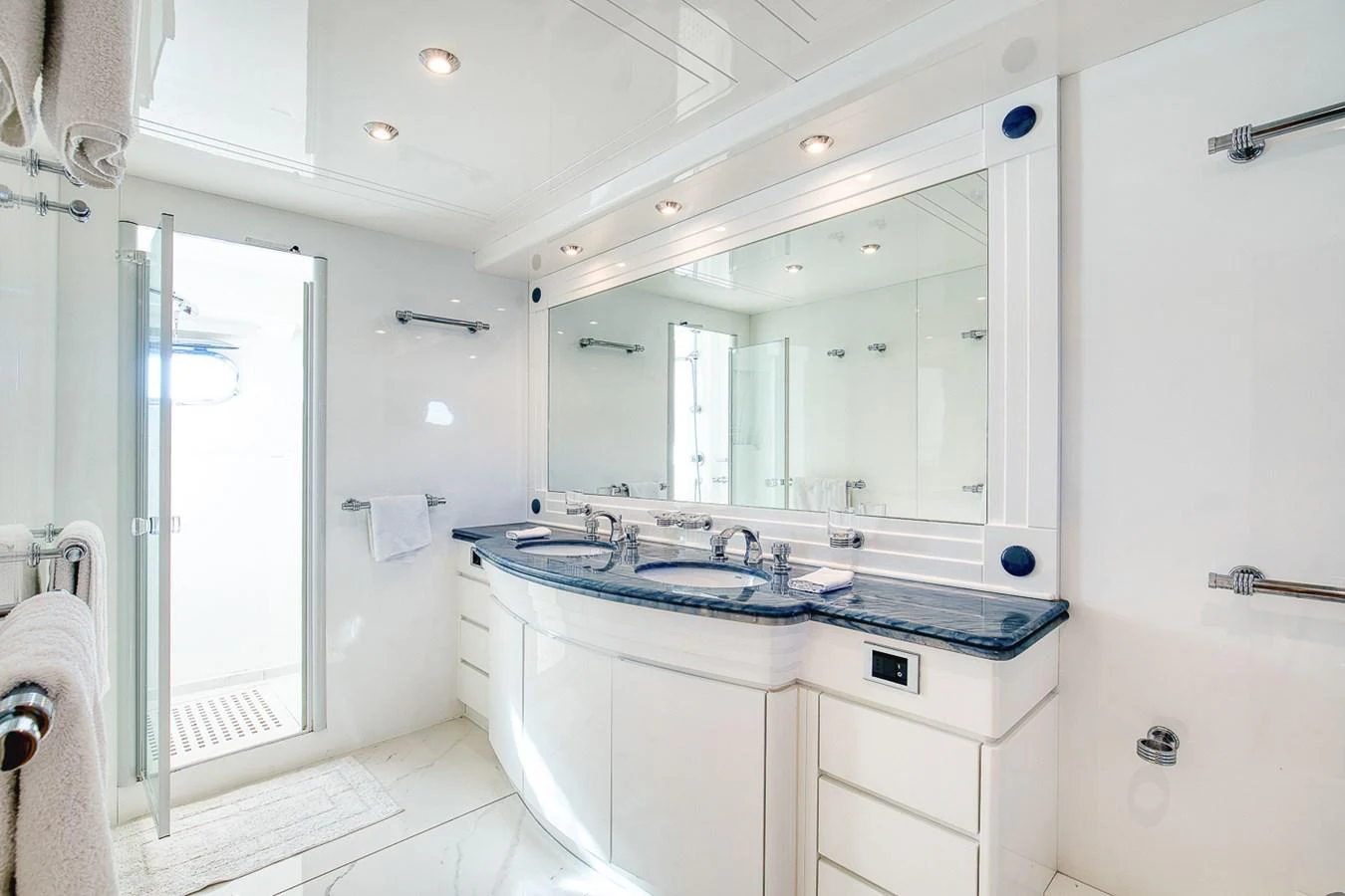 A luxurious yacht bathroom featuring dual sinks and a spacious shower area. aboard D-FORCE Yacht for Sale