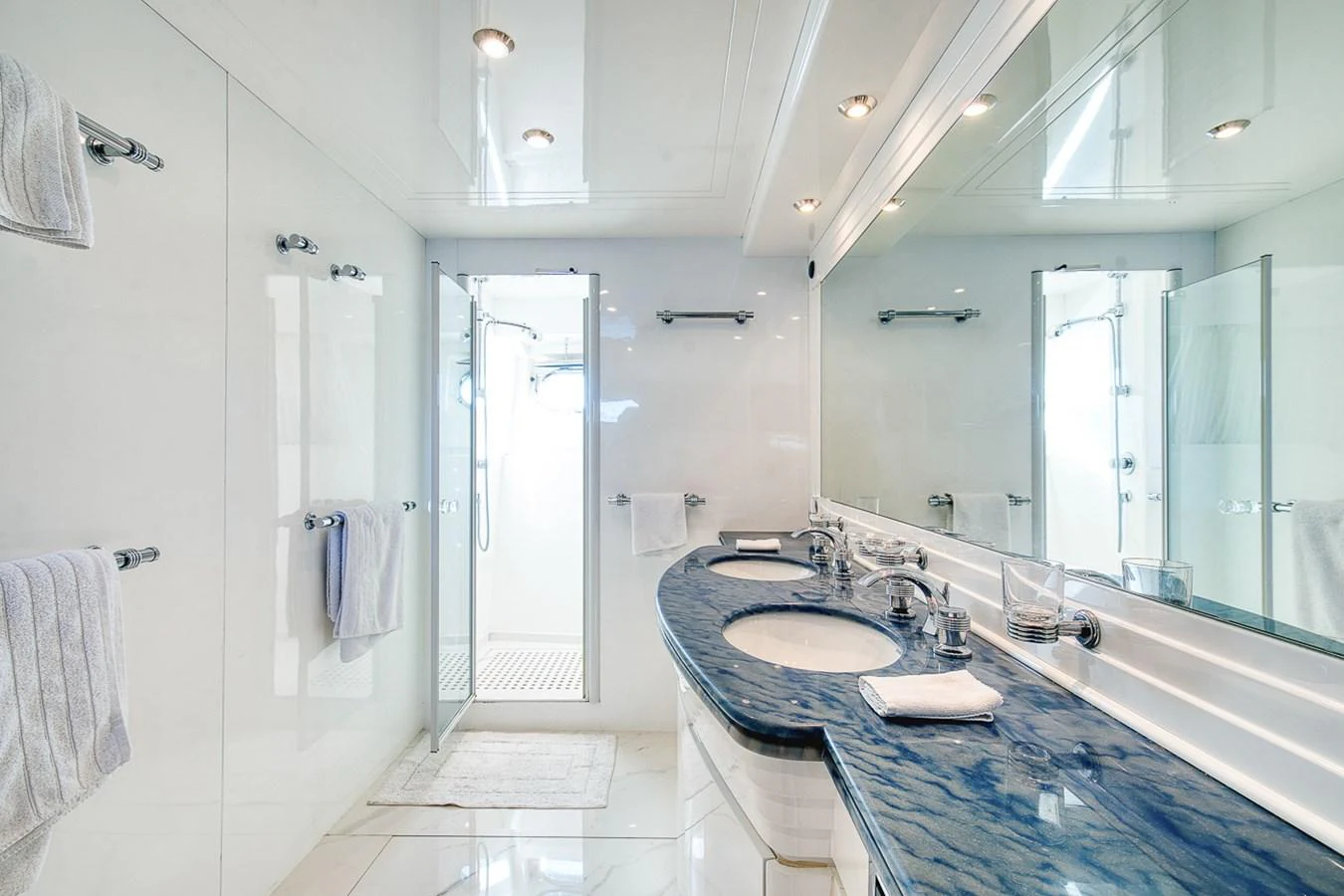 A luxurious yacht bathroom featuring dual sinks and a spacious shower area. aboard D-FORCE Yacht for Sale