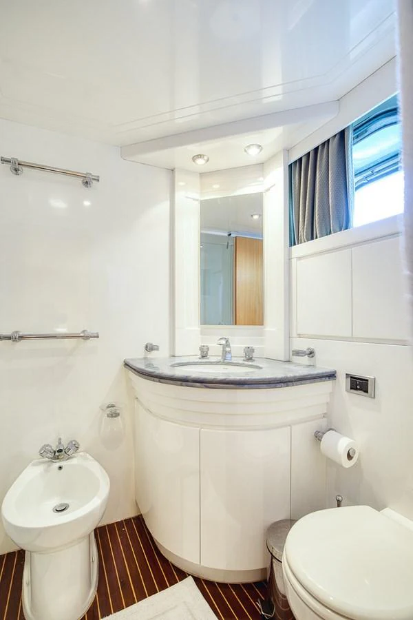 A pristine yacht bathroom featuring modern fixtures and a sleek design. aboard D-FORCE Yacht for Sale