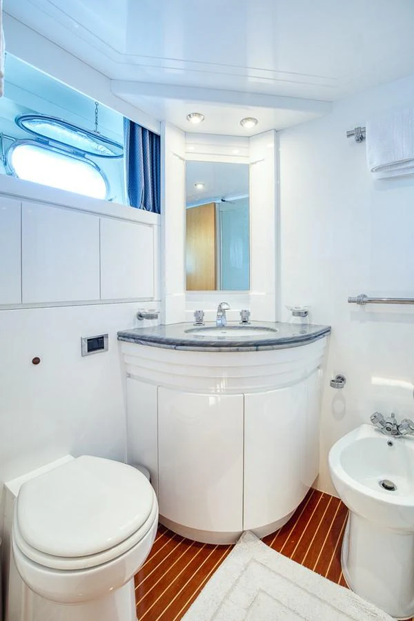 A pristine yacht bathroom featuring modern fixtures and a sleek design. aboard D-FORCE Yacht for Sale