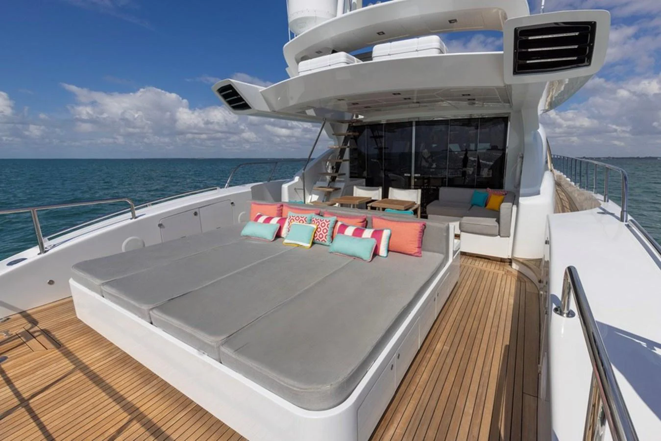 The aft deck features a spacious sunbathing area with plush cushions and a stylish seating arrangement, perfect for relaxation. aboard SAYONARA Yacht for Sale