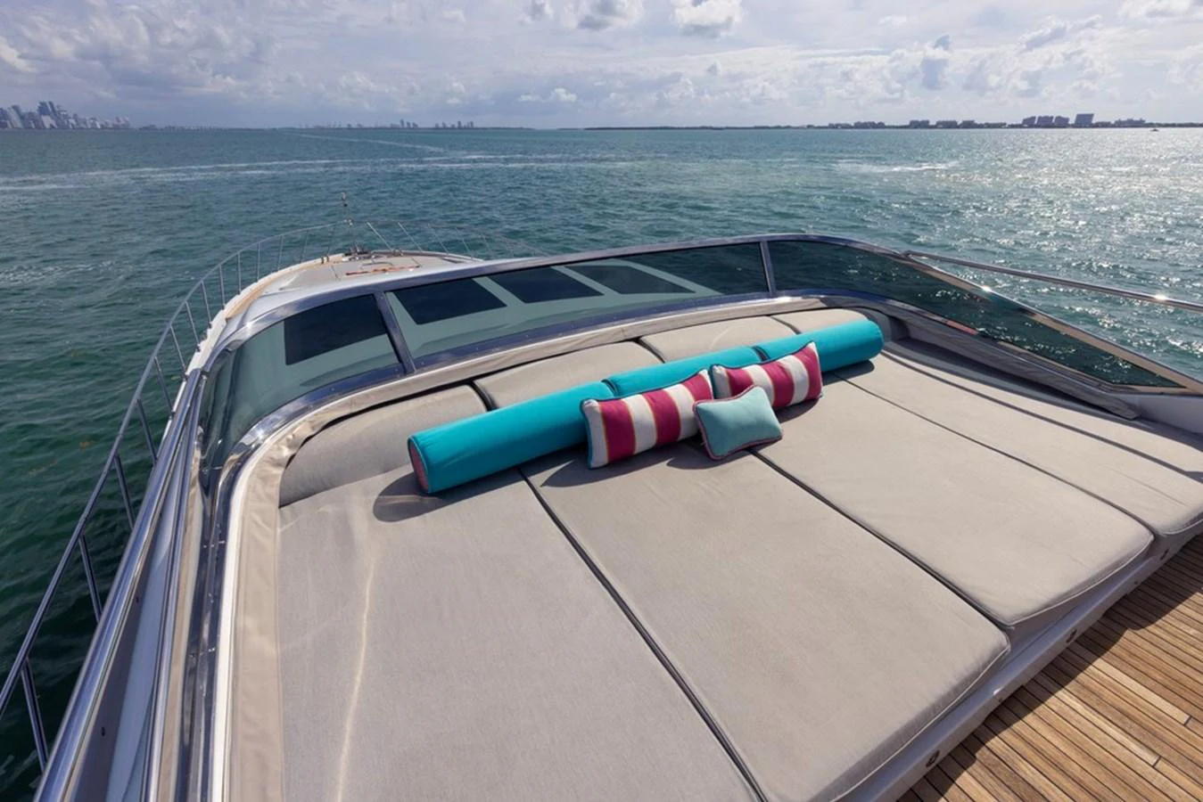 The yacht features a spacious sundeck with comfortable lounging pads and vibrant cushions, perfect for relaxation while enjoying the sea view. aboard SAYONARA Yacht for Sale