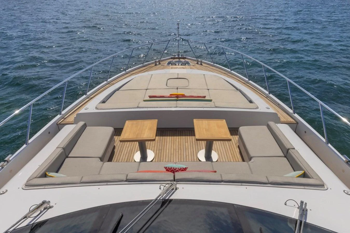 The yacht's foredeck features a spacious sunbathing area with comfortable seating and tables, perfect for relaxation. aboard SAYONARA Yacht for Sale