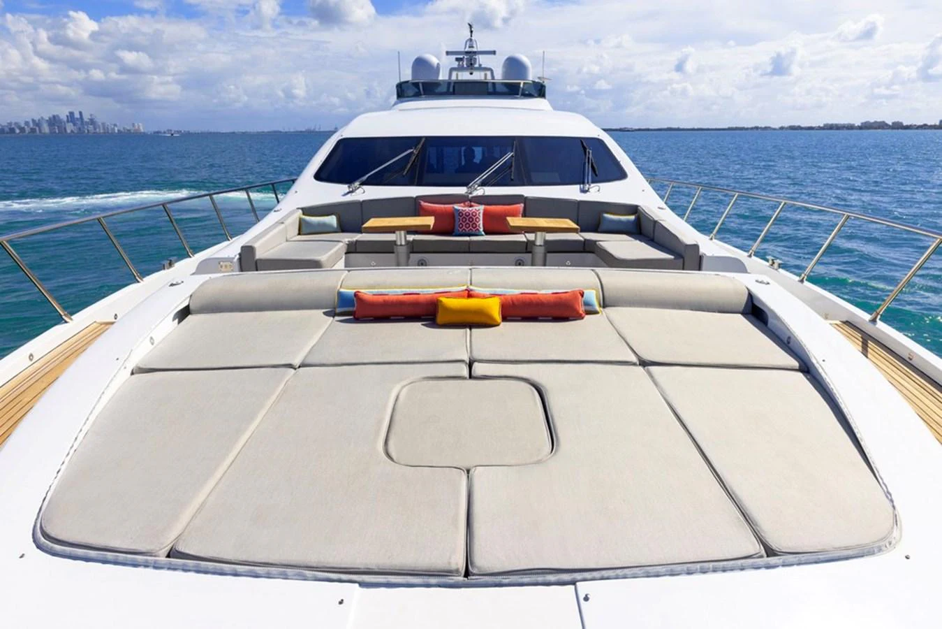 The yacht's foredeck features spacious sun pads and comfortable seating with vibrant cushions, perfect for relaxation. aboard SAYONARA Yacht for Sale