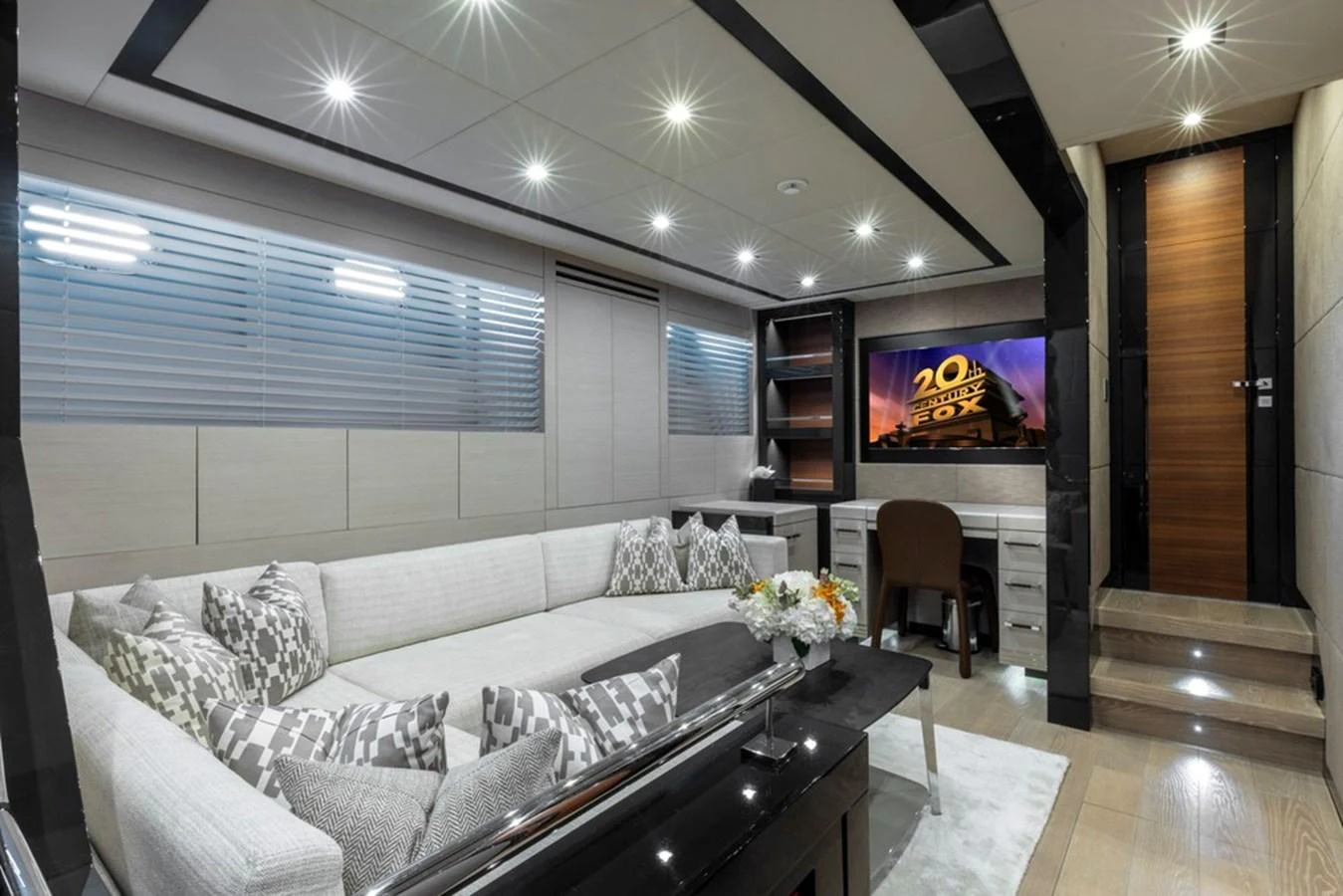 The yacht's interior features a modern lounge area with a comfortable sectional sofa and a built-in entertainment system. aboard SAYONARA Yacht for Sale