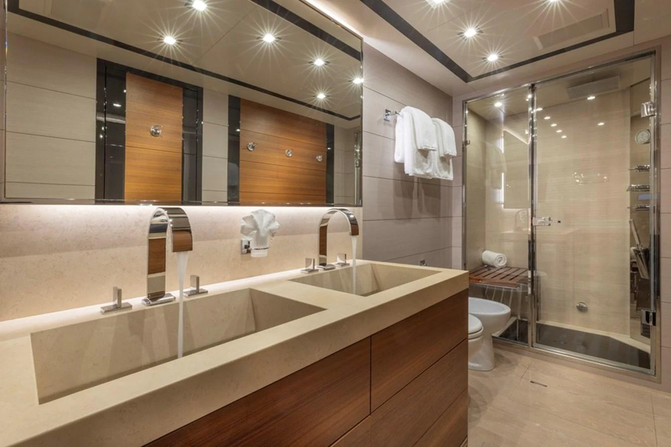 The yacht's bathroom features a modern design with dual sinks and a spacious shower area. aboard SAYONARA Yacht for Sale