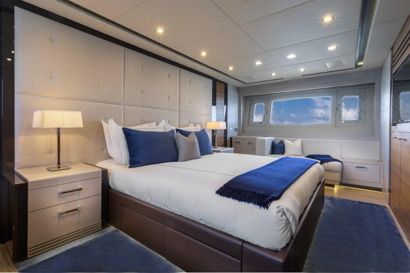 The master stateroom features a luxurious bed with plush bedding and elegant lighting. aboard SAYONARA Yacht for Sale
