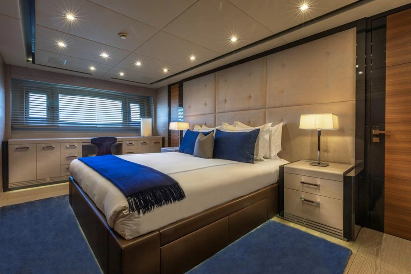 The master stateroom features a luxurious bed with plush bedding and elegant lighting. aboard SAYONARA Yacht for Sale