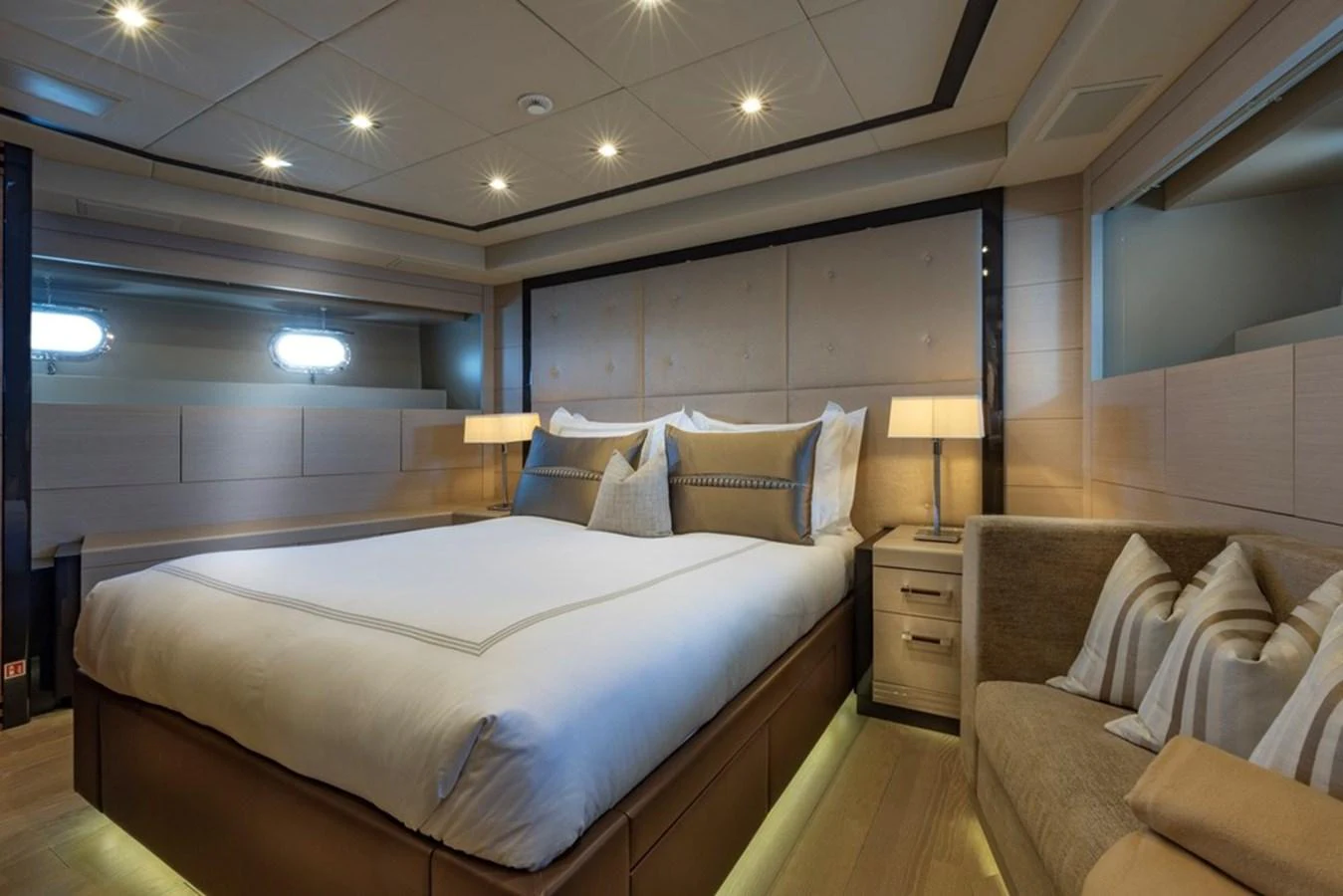 The master stateroom features a luxurious bed with elegant lighting and modern decor. aboard SAYONARA Yacht for Sale
