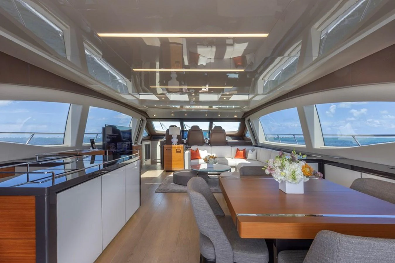 The spacious salon features modern furnishings and panoramic windows, offering a luxurious and comfortable setting. aboard SAYONARA Yacht for Sale