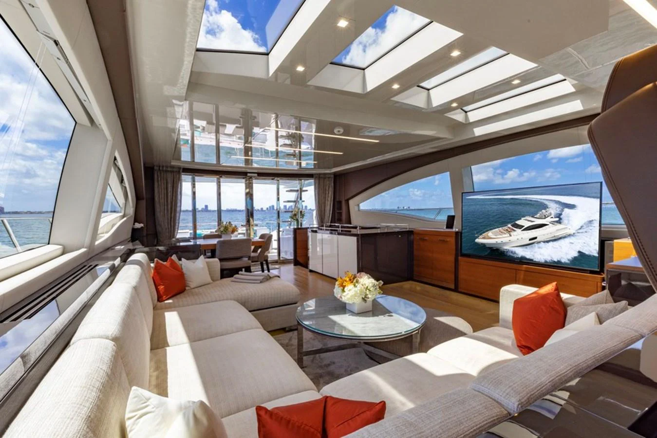 The yacht's salon features a spacious and luxurious seating area with large windows offering panoramic views. aboard SAYONARA Yacht for Sale