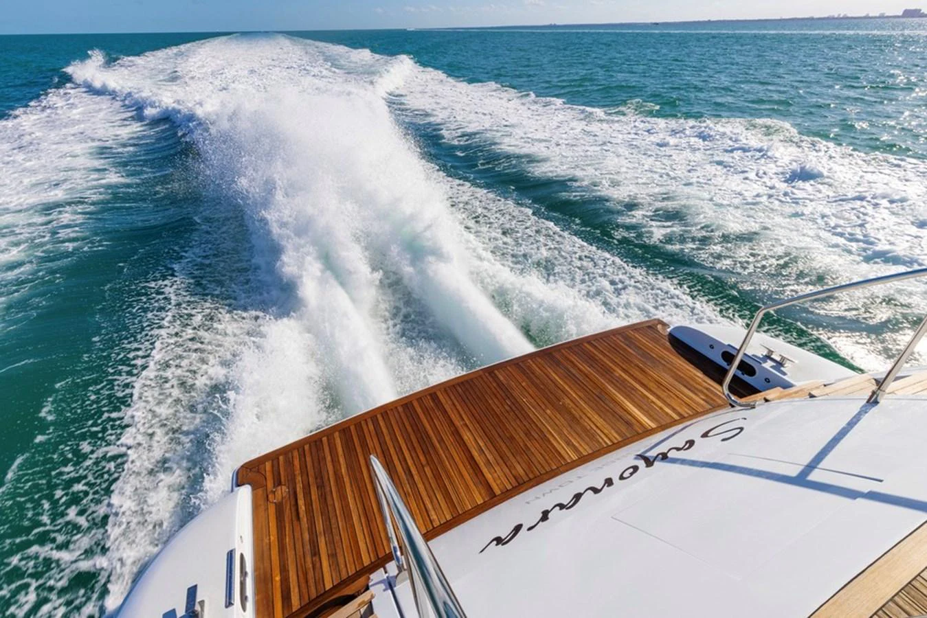 The yacht's aft deck offers a stunning view of the wake as it cruises through the open water. aboard SAYONARA Yacht for Sale