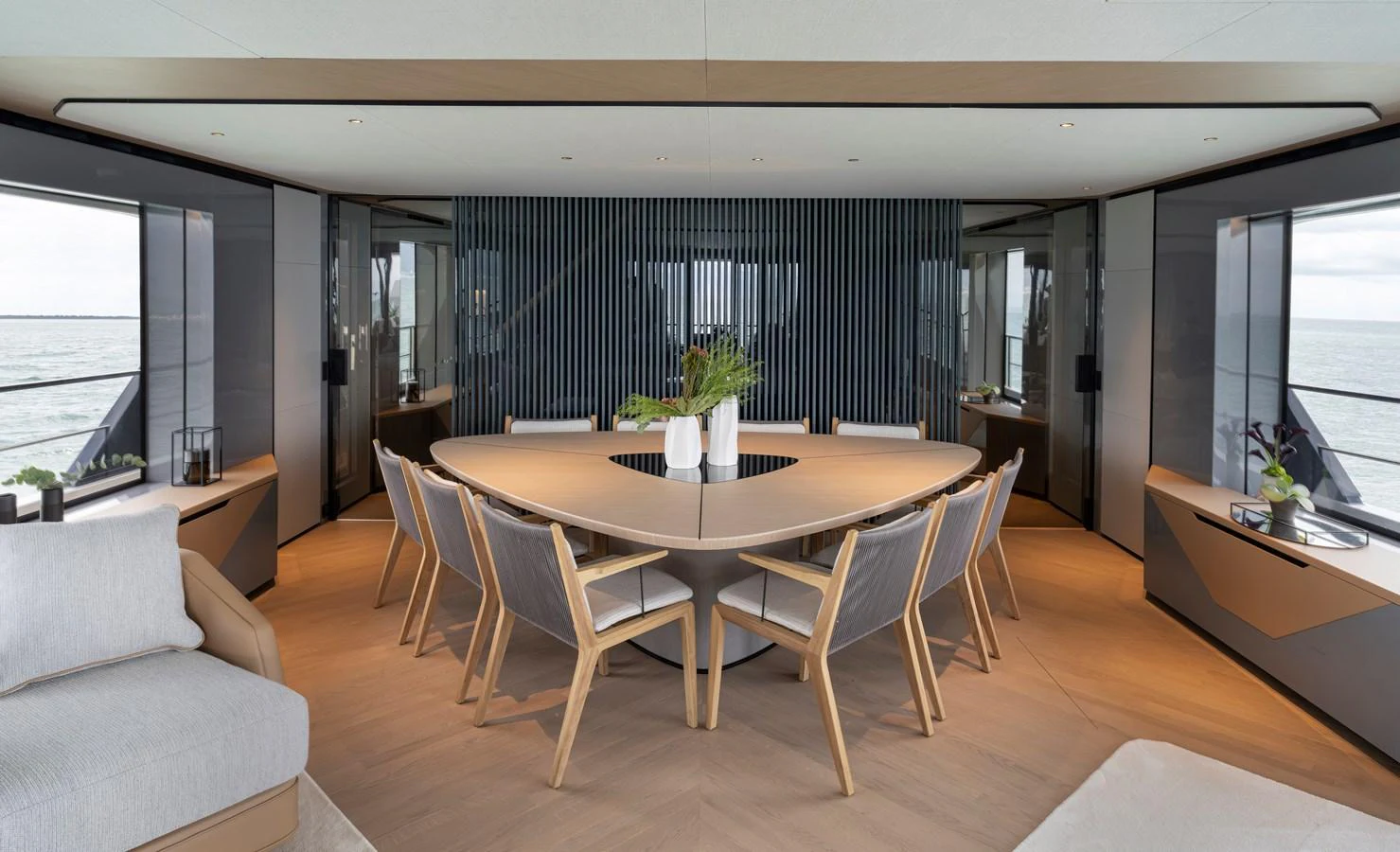 The yacht's dining area features a modern table surrounded by stylish chairs, offering a sophisticated setting for meals. aboard AZIMUT GRANDE 30M NEW Yacht for Sale