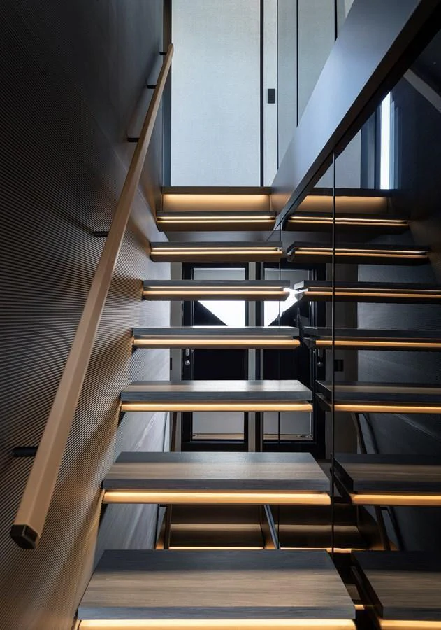 A modern staircase with sleek lines and ambient lighting enhances the yacht's interior elegance. aboard AZIMUT GRANDE 30M NEW Yacht for Sale
