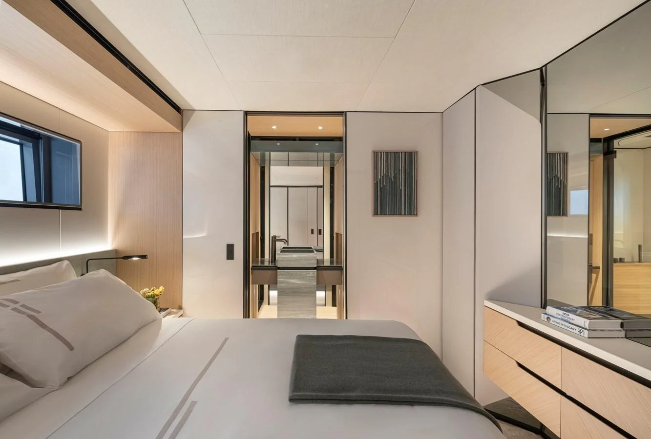 The stateroom features a luxurious bed with modern decor and ample natural light. aboard AZIMUT GRANDE 30M NEW Yacht for Sale
