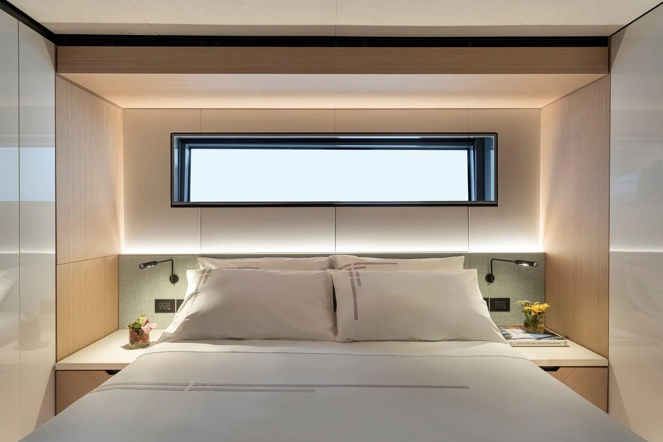 The stateroom features a luxurious bed with modern lighting and elegant decor. aboard AZIMUT GRANDE 30M NEW Yacht for Sale