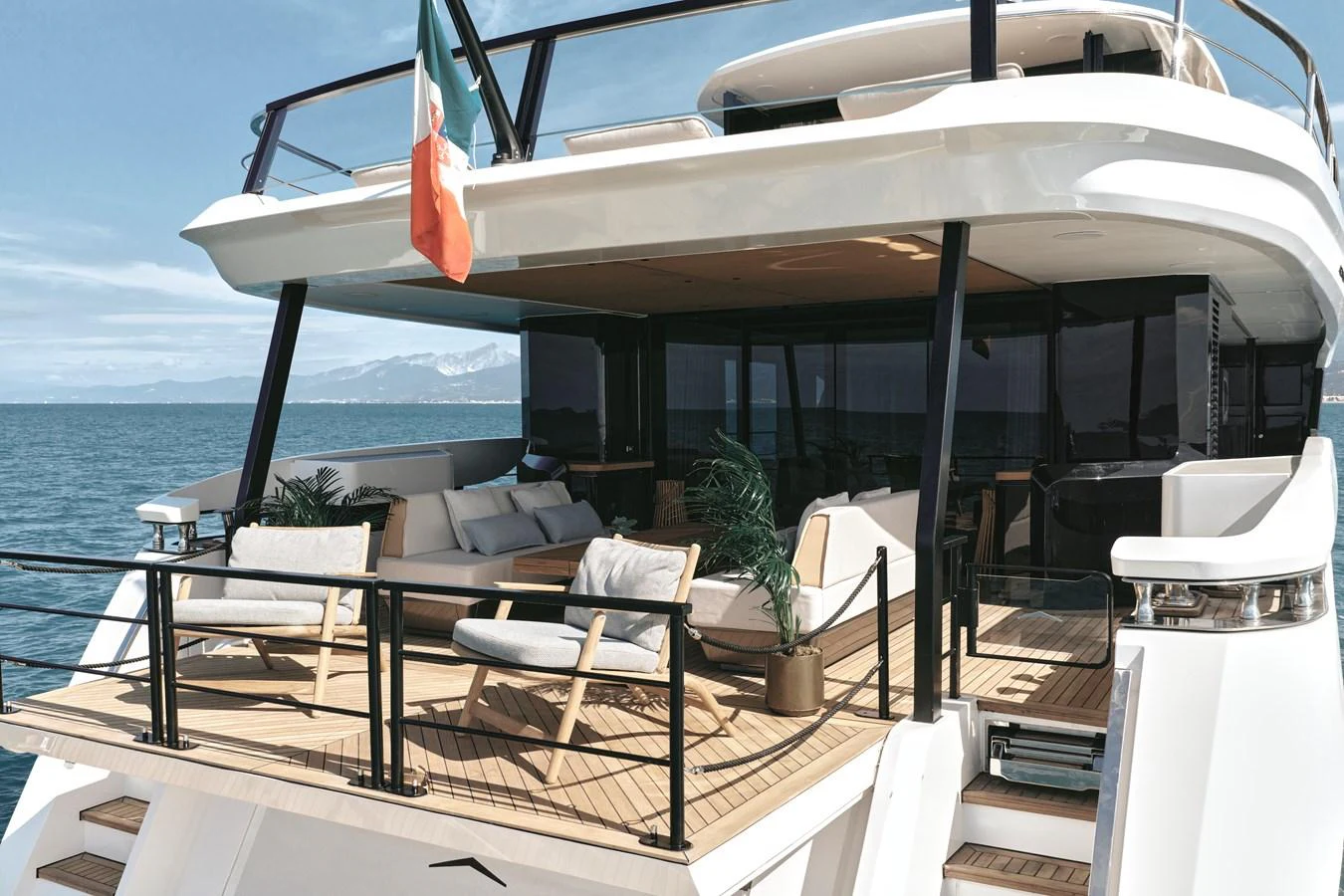 The aft deck offers a luxurious outdoor seating area with stunning views of the sea. aboard AZIMUT GRANDE 30M NEW Yacht for Sale