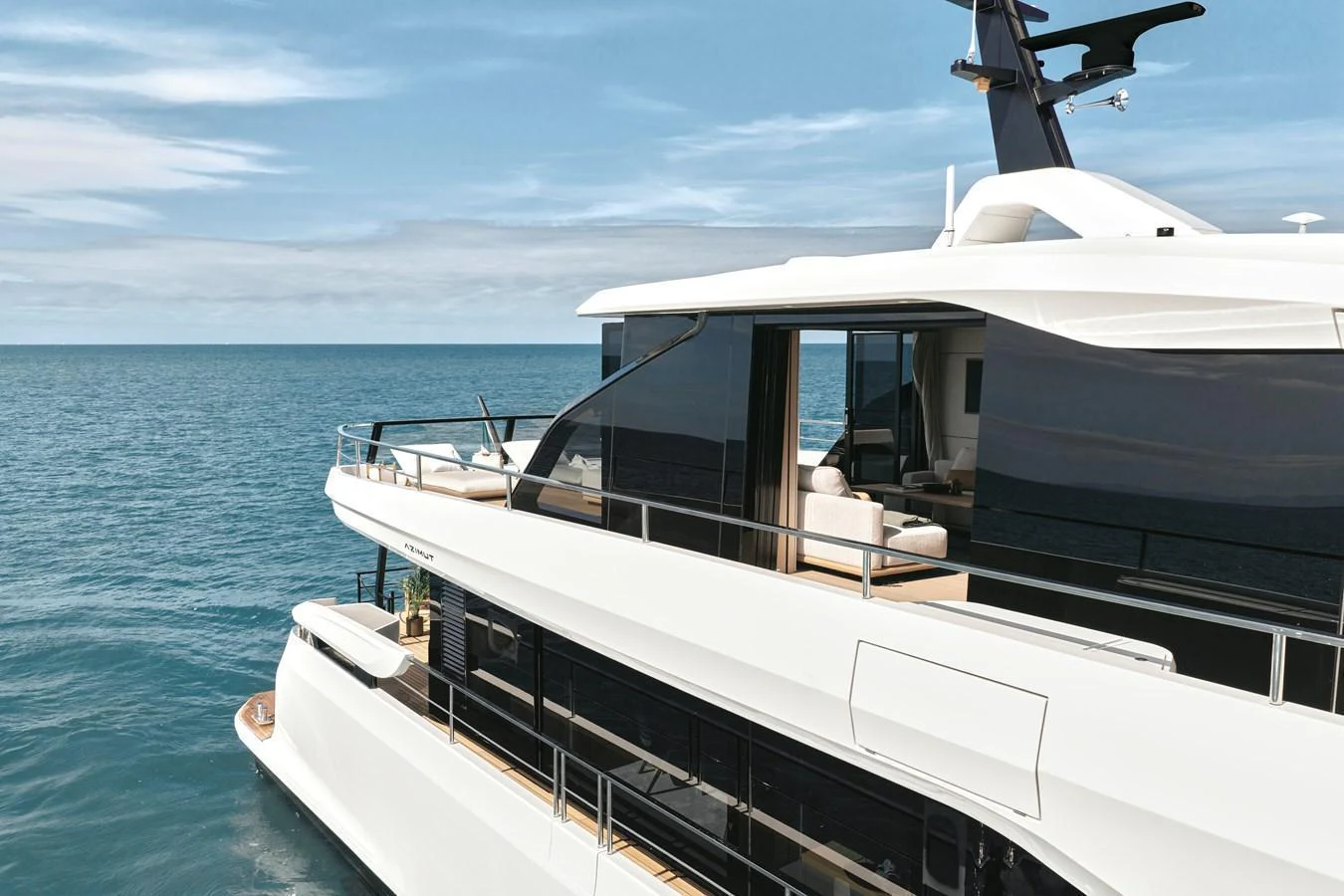 A sleek and modern yacht cruising on calm blue waters under a clear sky. aboard AZIMUT GRANDE 30M NEW Yacht for Sale