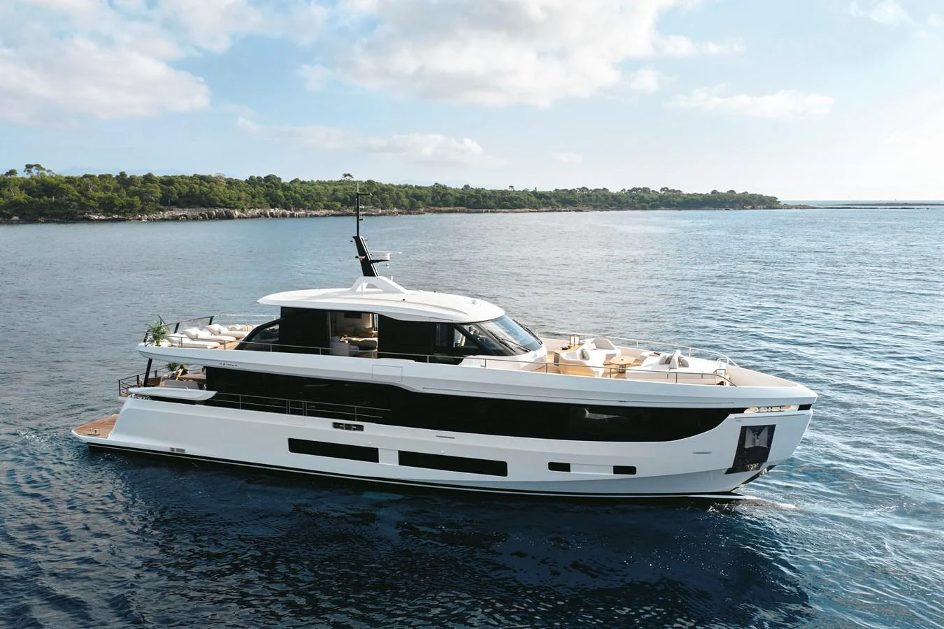A sleek and modern yacht cruising on calm waters with a scenic coastline in the background. aboard AZIMUT GRANDE 30M NEW Yacht for Sale