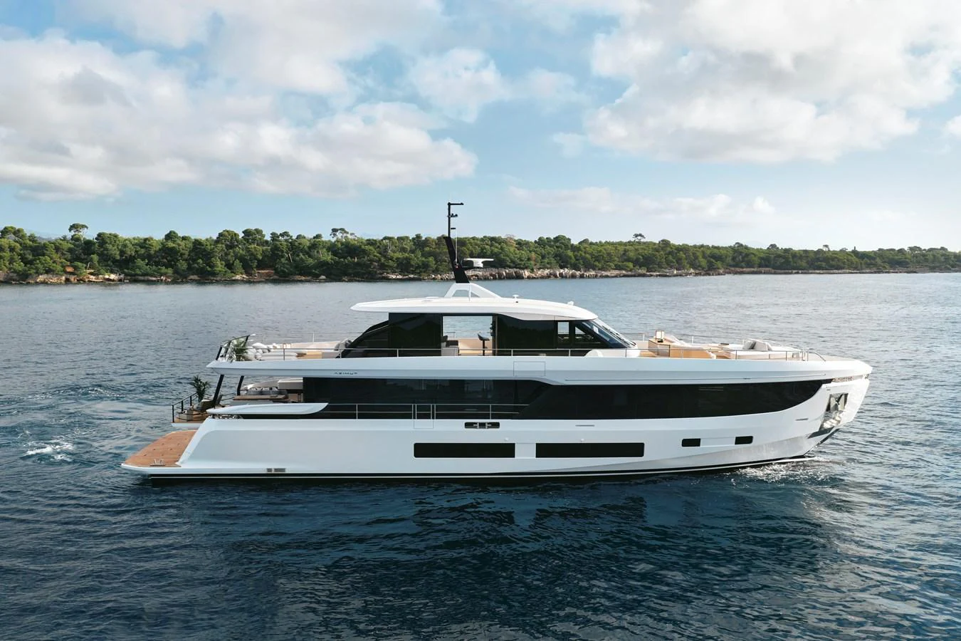 A sleek and modern yacht cruising on calm waters with a scenic coastline in the background. aboard AZIMUT GRANDE 30M NEW Yacht for Sale