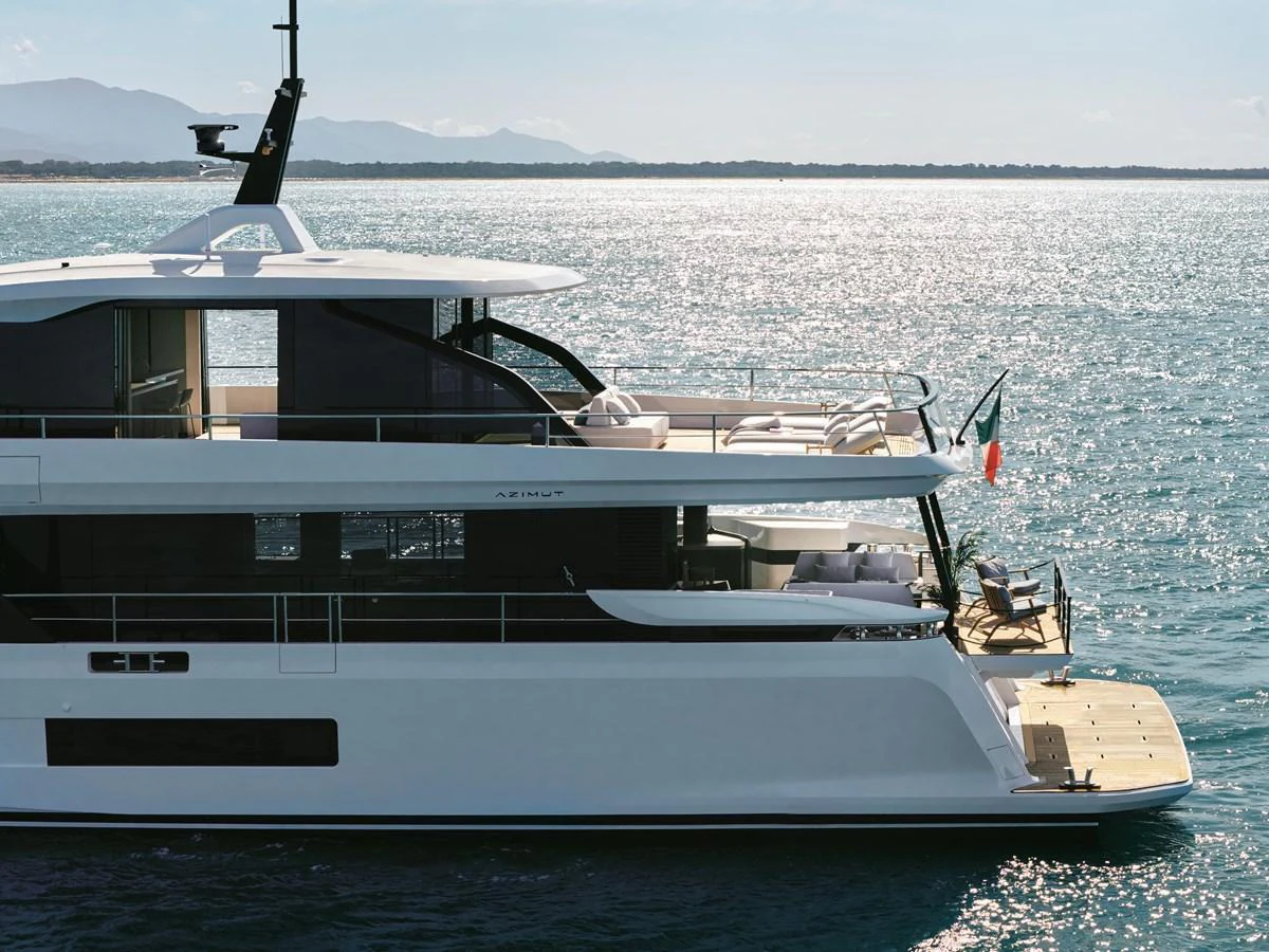 A sleek and modern yacht glides gracefully on calm waters under a clear sky. aboard AZIMUT GRANDE 30M NEW Yacht for Sale