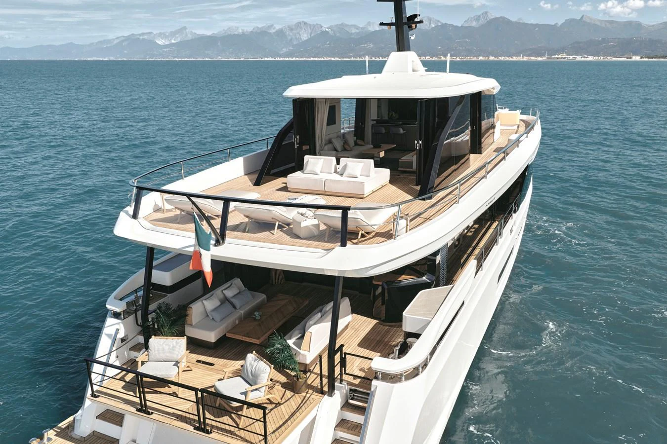 A luxurious yacht cruising on the open sea, showcasing its spacious aft deck and upper lounge areas. aboard AZIMUT GRANDE 30M NEW Yacht for Sale