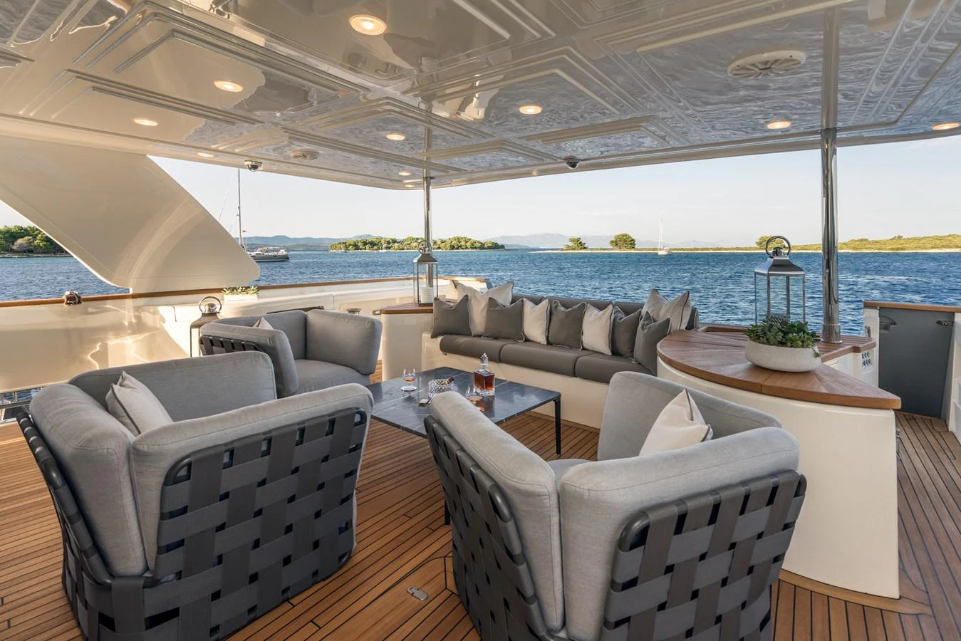 The aft deck offers a luxurious seating area with a stunning view of the water. aboard SEVENTH SENSE Yacht for Sale