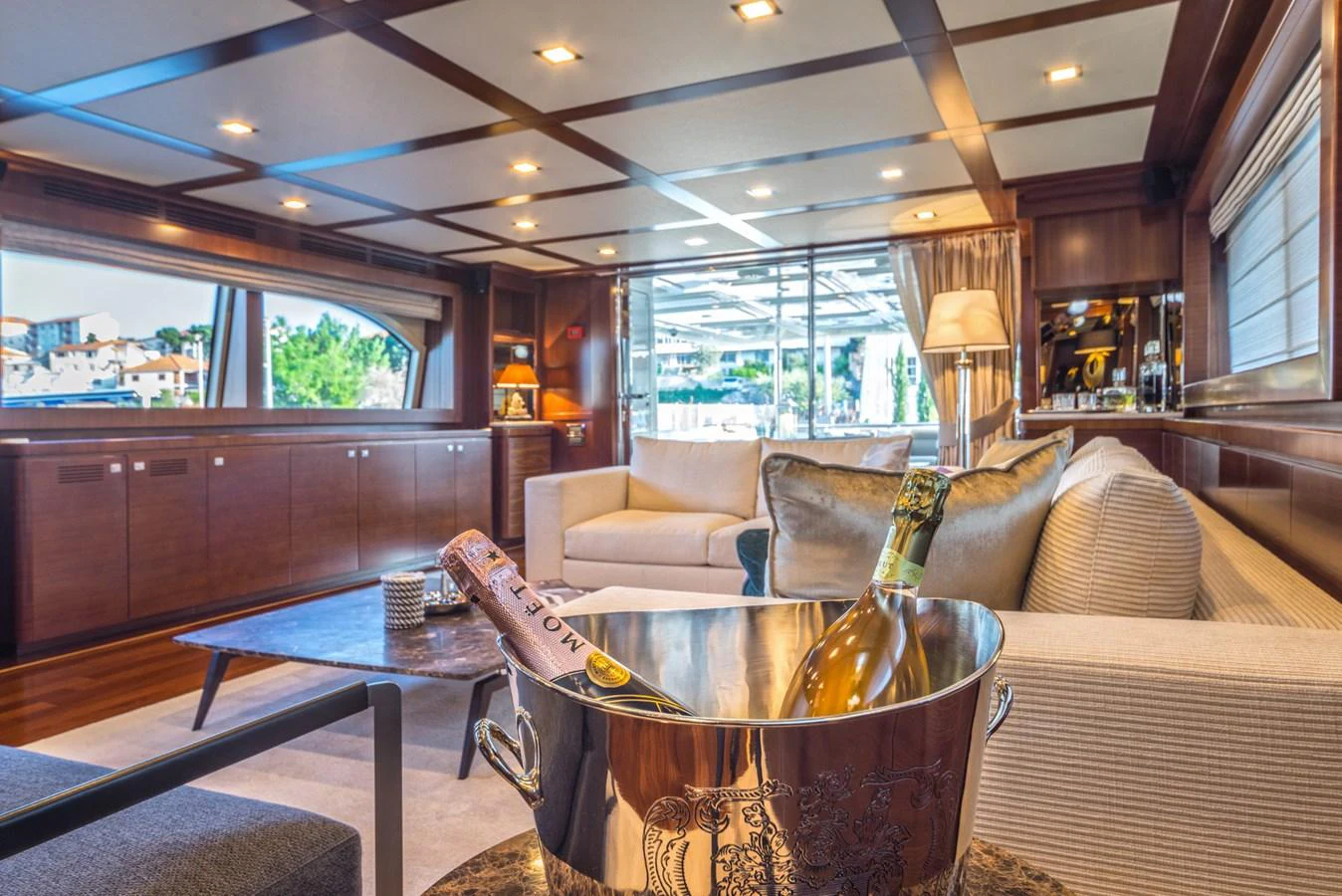 The luxurious salon features elegant seating, warm wooden finishes, and a welcoming ambiance. aboard SEVENTH SENSE Yacht for Sale